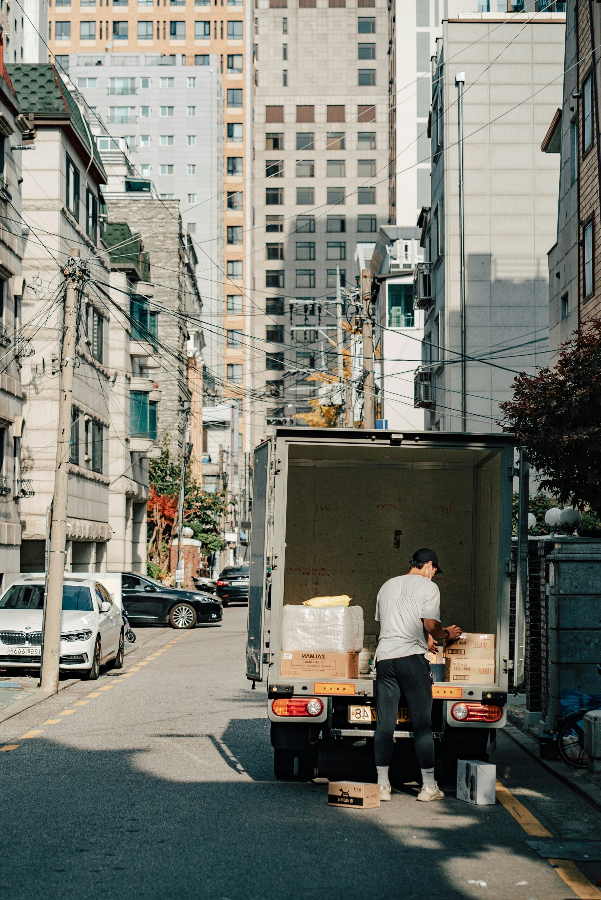 a man unloading boxes from the back of a moving truck